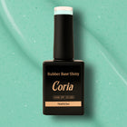 Baza Rubber Shiny Coria 063 15 ml – flacon negru pe fundal mentă sclipitor