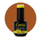 Ojă semipermanentă Coria Yellow Vibes 74, flacon 15 ml pe fundal maro-portocaliu