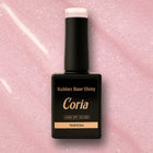 Baza Rubber Shiny Coria 802023 15 ml – flacon negru pe fundal roz sclipitor