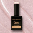 Baza Rubber Shiny Coria 073 15 ml – flacon negru pe fundal roz sclipitor
